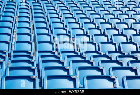 Folded blue plastic chairs on a temporary  tribune Stock Photo