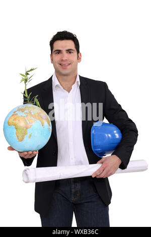 Architect holding globe and plans Stock Photo