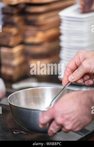 Chef hands beating eggs in a bowl . Stock Photo