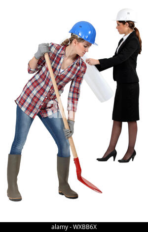 Female builder with spade Stock Photo