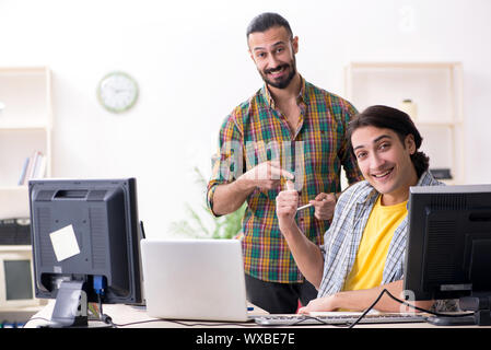 Two it specialists working in the office Stock Photo