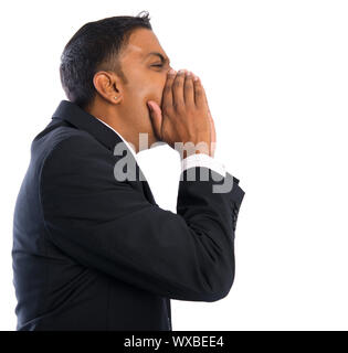Side view of Asian Indian businessman shouting over white background Stock Photo