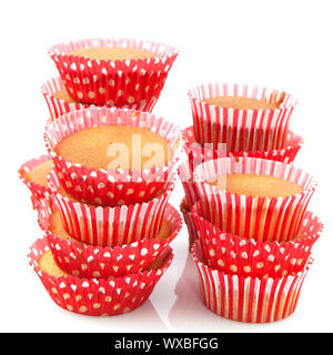 Many cup cakes in red baked and isolated over white Stock Photo