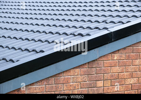 Roof tiles and brick wall - fragment of typical residential building in Australia Stock Photo