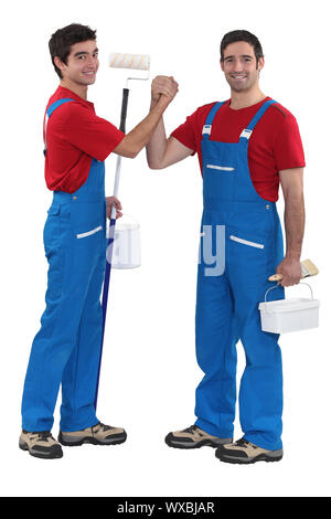 craftsman painter and his apprentice shaking hands Stock Photo