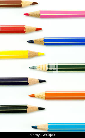 colored pencils facing each other on a white background Stock Photo