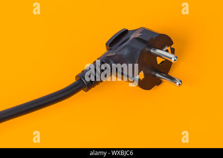 Electrical plug on orange background Stock Photo