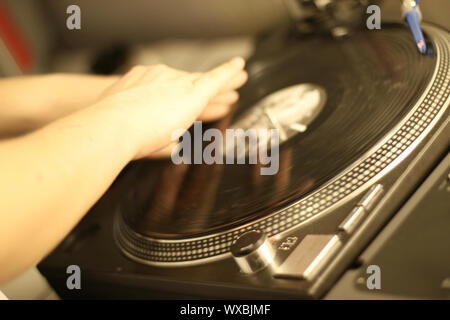 scratch battle of dj playing on his vinyls hand on Stock Photo