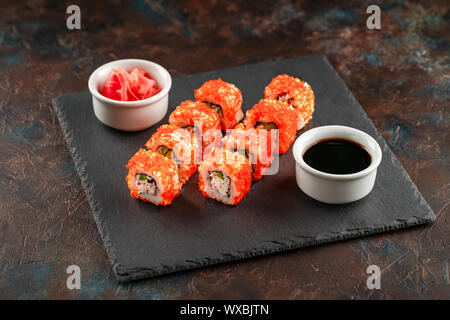 Japanese sushi on a rustic dark background. Stock Photo