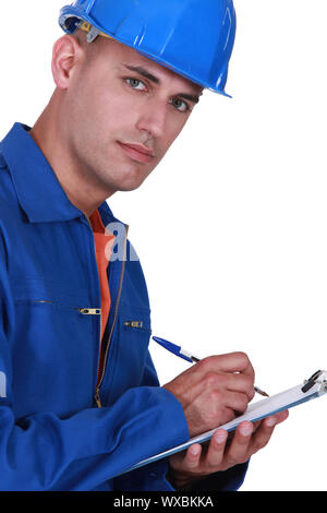 Inspector writing on clip-board Stock Photo