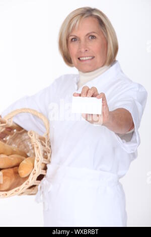 Female bakery worker displaying card Stock Photo