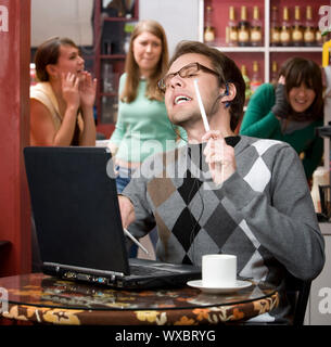 Obnoxious young man singing loudly in a coffee house Stock Photo