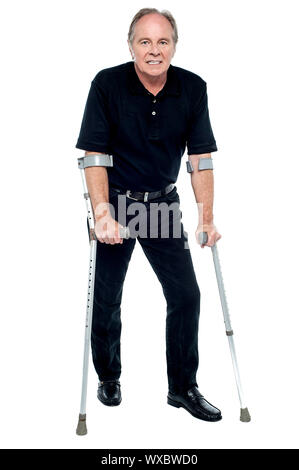 Senior citizen taking his first steps after his successful surgery. Looking at the camera. Stock Photo