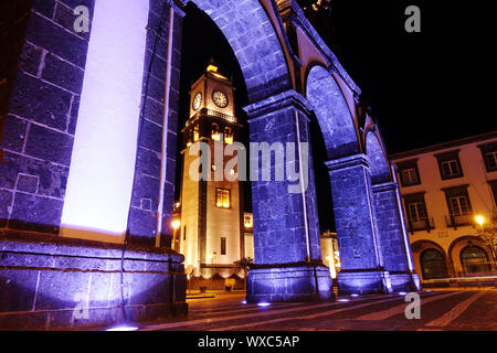 historic city gate on the Largo de Goncalo Velho Cabral, in background the main church Sao Sebastiao Stock Photo