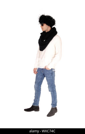 Tall young man standing in profile with fur hat Stock Photo