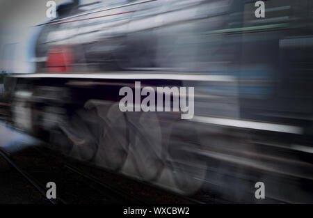 Classic vinatage steam train racing passed with motion blur Stock Photo