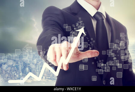 Businessman Touching a Graph Indicating Growth Stock Photo