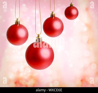 Red christmas ornaments with pink lights background Stock Photo