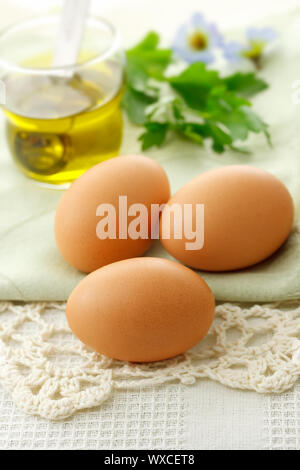 Fresh eggs with olive oil on the table Stock Photo