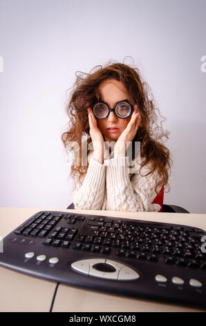 Funny nerd girl working on computer Stock Photo