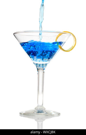 Blue cocktail being poured into a glass on white background Stock Photo