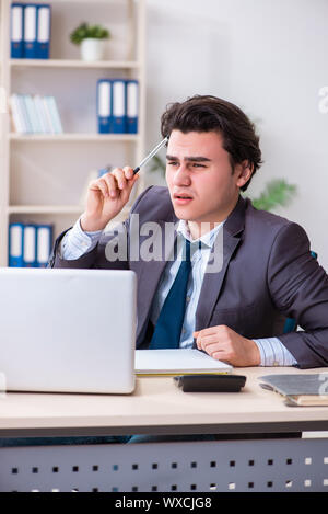 Young male employee working  in the office Stock Photo