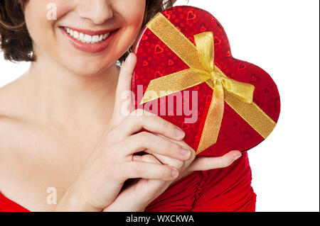 Cropped image of joyous female model displaying gift for her lover. Stock Photo