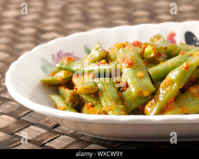 close up of a plate of stir fried long beans in chili shrimp paste Stock Photo