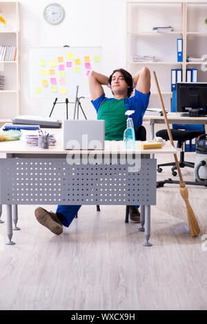 Male handsome professional cleaner working in the office Stock Photo