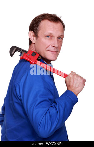 worker carrying pipes on his shoulder on construction site Stock Photo ...