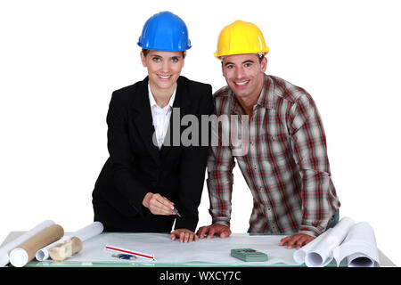 Architect and builder looking at plans Stock Photo
