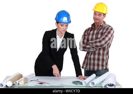 Architect and builder discussing plans Stock Photo