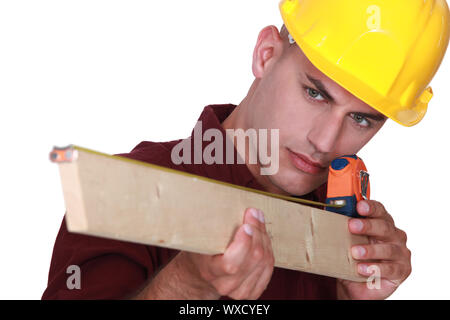 craftsman measuring a board Stock Photo