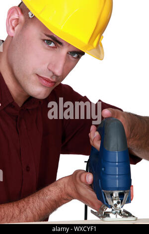 craftsman making holes in a board Stock Photo