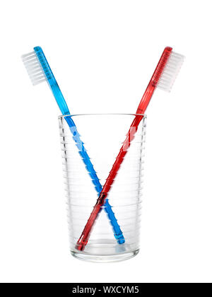 Two toothbrushes in a glass over white background. Stock Photo