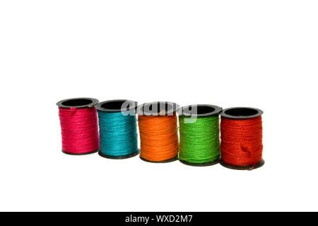 Five different colours of spools of thread Stock Photo