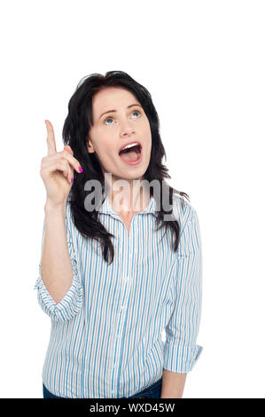 Astonished young woman pointing her index finger upwards, mouth wide open. Stock Photo