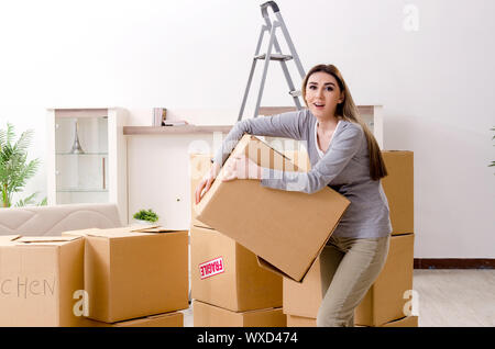 Young beautiful woman moving to new flat Stock Photo