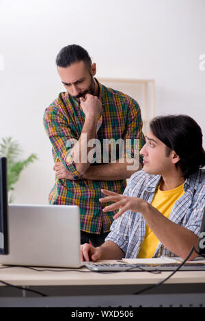 Two it specialists working in the office Stock Photo