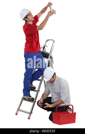 Two electricians working together Stock Photo