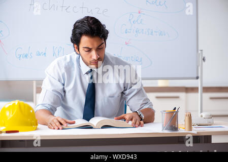 Young male architect in front of the whiteboard Stock Photo
