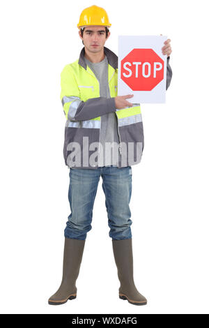 bricklayer holding stop sign Stock Photo