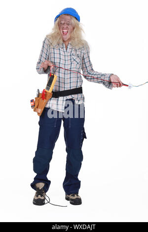 Woman receiving electrical shock Stock Photo