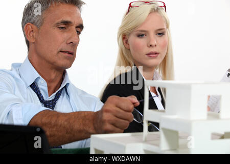Architects examining a model Stock Photo