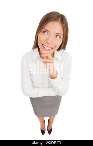 Thinking beautiful smiling business woman looking up isolated on white background in high angle view. Mixed race ethnic Asian Chinese / Caucasian busi Stock Photo