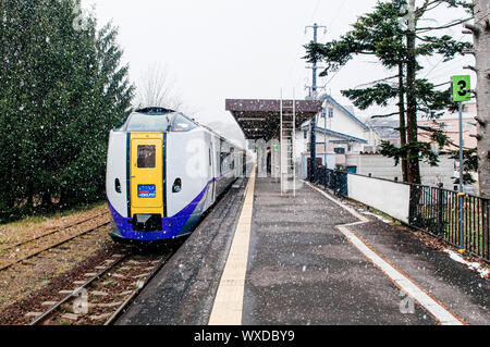 DEC 1, 2018 Hakodate, JAPAN - JR Suoer Hokuto train stop at Onuma Koen station  platform during snow fall in winter foggy atmosphere Stock Photo