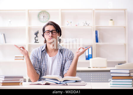 Young male student preparing for exams at home Stock Photo