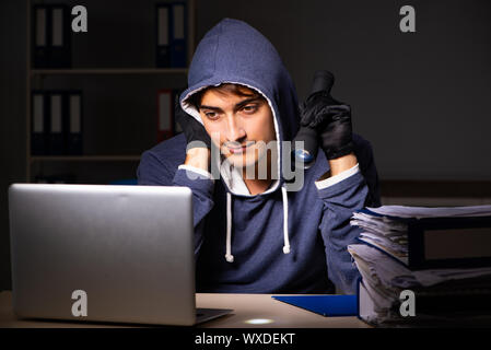 Thief trying to steal personal data in identity theft concept Stock Photo