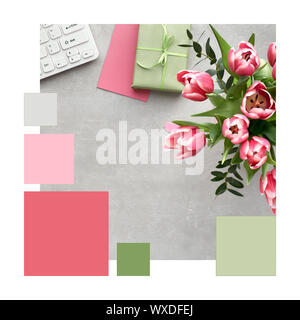 Trendy color matching complementary palette from Springtime workspace, flat lay with pink tulips, eucalyptus, keyboard, cards and gift box on stone Stock Photo
