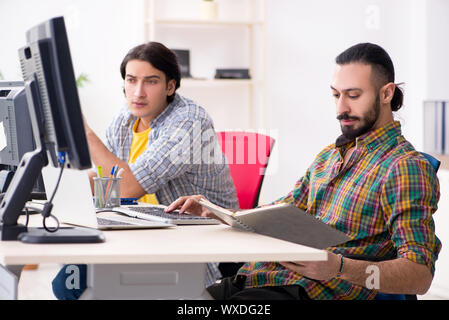 Two it specialists working in the office Stock Photo